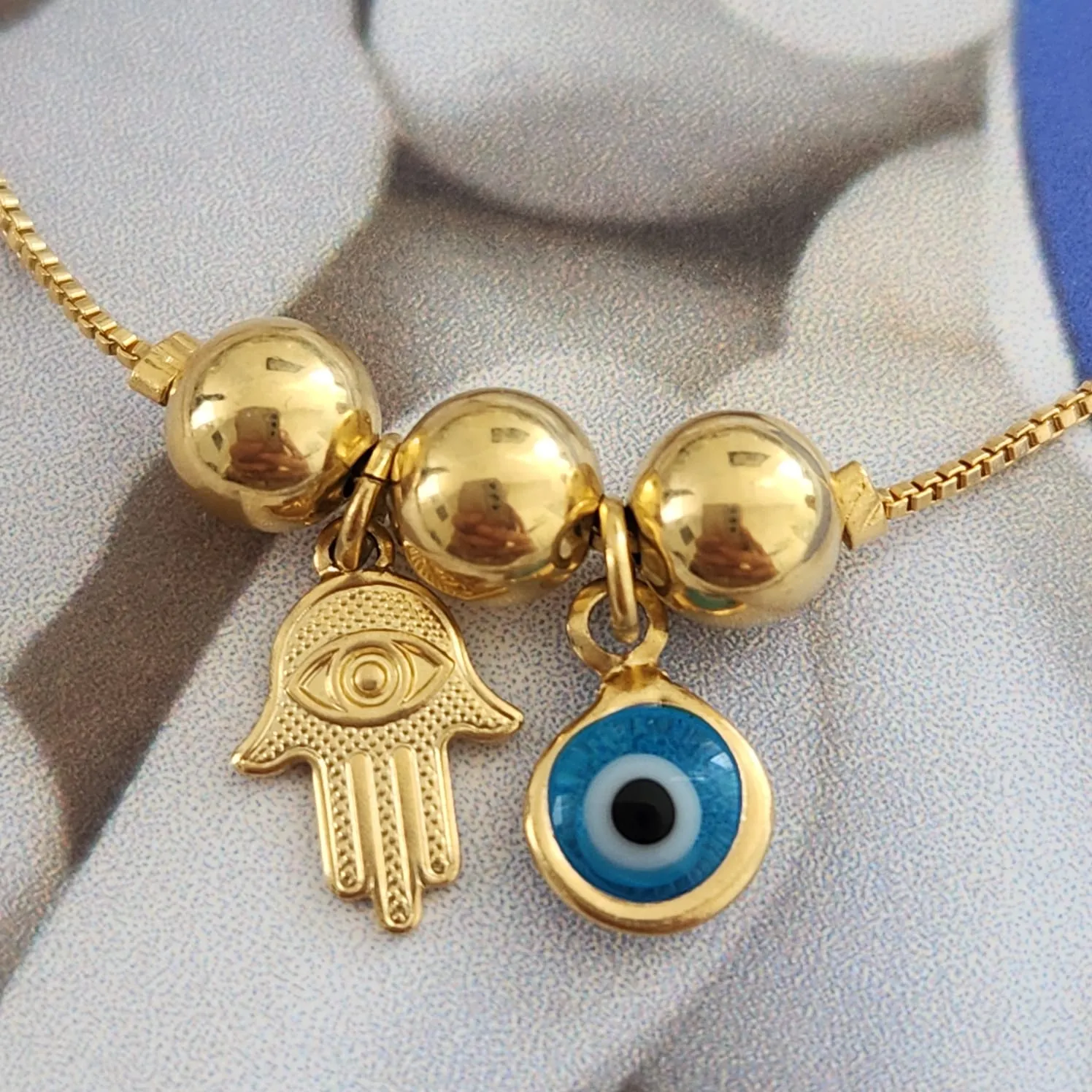 PULSEIRA DOURADA OLHO GREGO E MÃO DE FÁTIMA