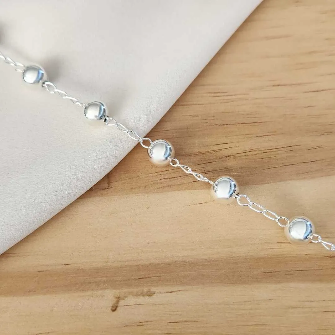 PULSEIRA BANHO DE PRATA COM BOLAS DETALHE CRUZ