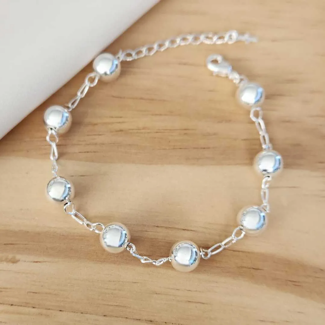 PULSEIRA BANHO DE PRATA COM BOLAS DETALHE CRUZ